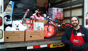 Travis Brant with toys for the children